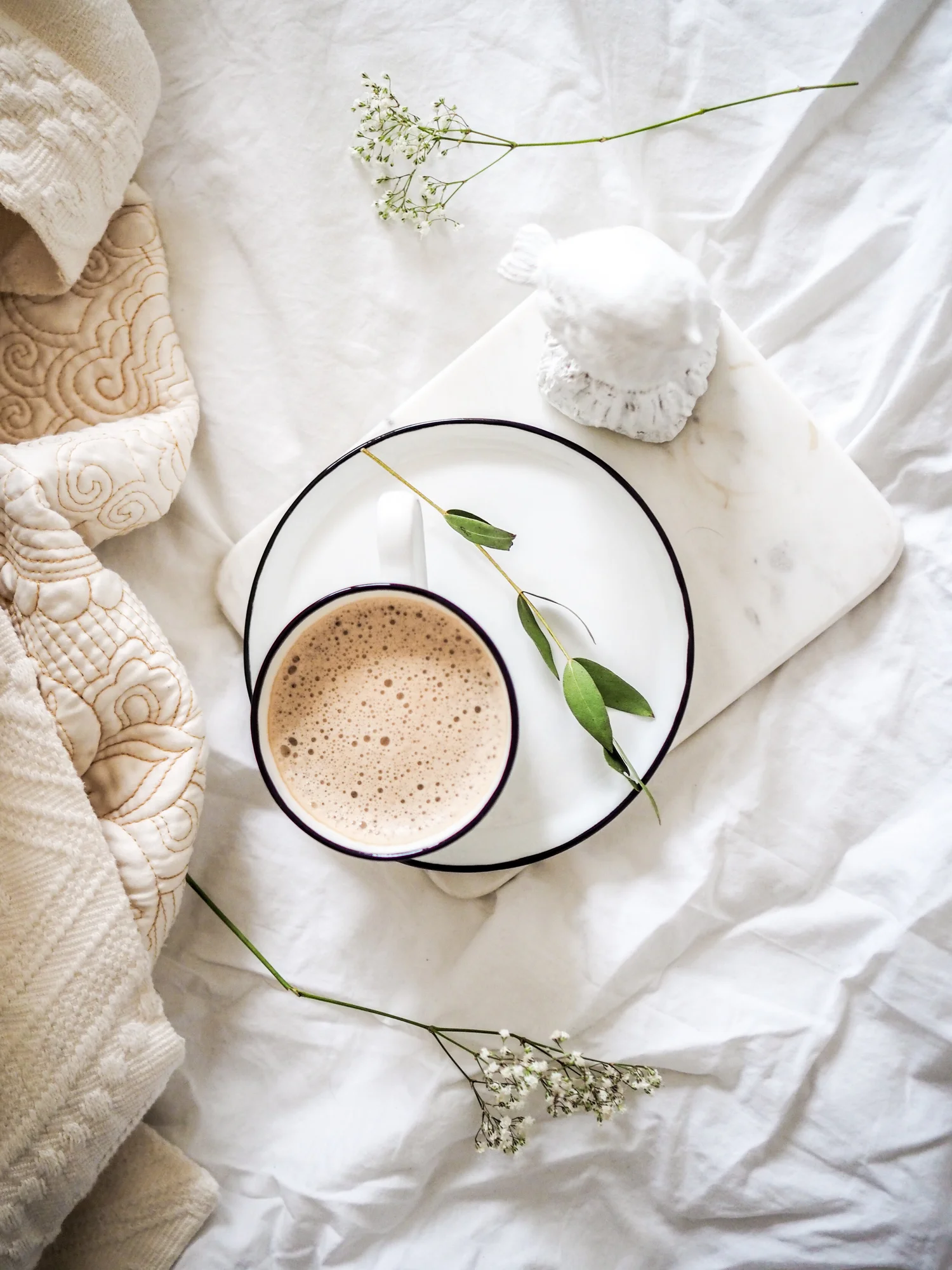 A cozy flat-lay of a coffee cup, evoking a warm space to relax